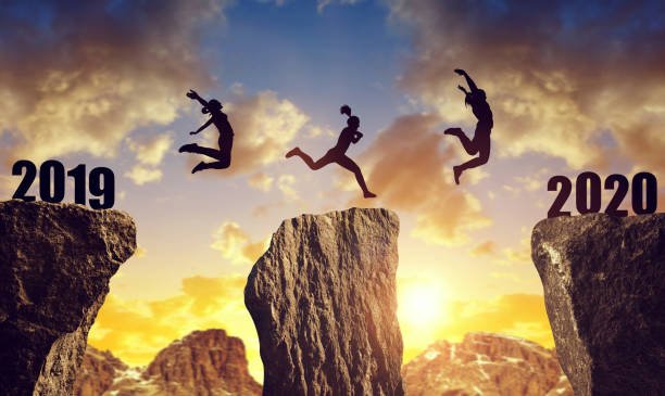  Silhouettes leap across a gap, symbolizing the journey to embrace imperfection and apply 7 Techniques to Break Free from Perfectionism.